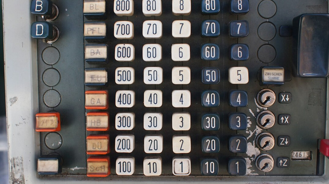 Close-up of printed survey questionnaires and statistical printouts with a calculator