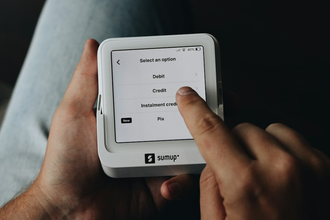 Hand holding a tablet displaying a survey application interface
